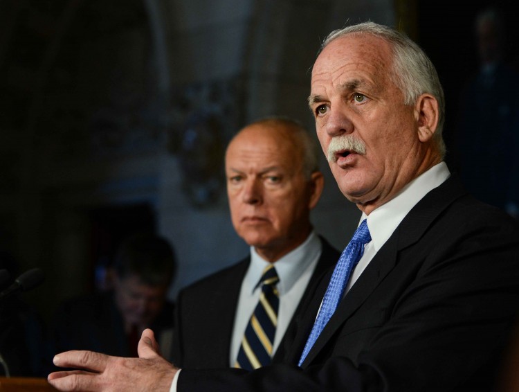 Canadian Public Safety Minister Vic Toews details changes he introduced to the Witness Protection Program Act to reporters on Parliament Hill on Dec. 11, 2012, as Senator Jean-Guy Dagenais looks on. (Matthew Little/The Epoch Times)