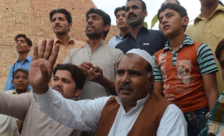 Villagers talk to media representatives following the execution of Mohammed Ajmal Kasab, who was hanged in an Indian prison, at Kasab's village in Farid kot, some 230 miles southeast of the Pakistani capital Islamabad on Nov. 21, 2012. (Arif Ali/AFP/Getty Images)