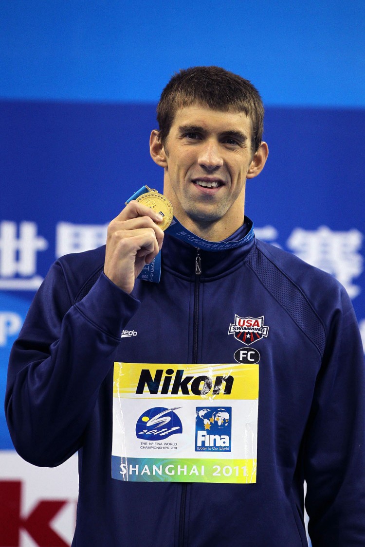 SWIMMING GOLD: Michael Phelps of the United States poses with his gold medal won in the Men's 200m Butterfly Final at the 14th FINA World Championships. (Ezra Shaw/Getty Images)