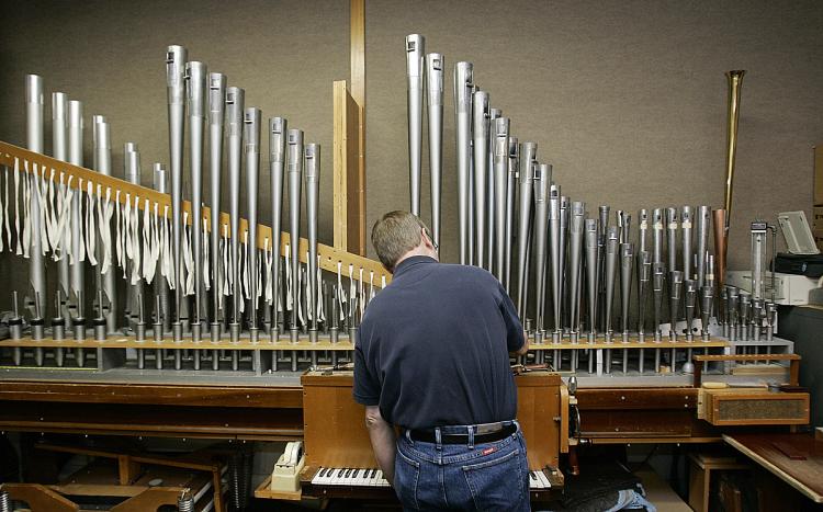 THE MAGNIFICENT PIPE ORGAN: Gene Hillebrecht, one of seven voicers for the Schantz Organ Company in Orrville, Ohio, works on a reed pipe at the oldest and largest U.S. pipe organ builder.   (Jeff Haynes/AFP/Getty Images)
