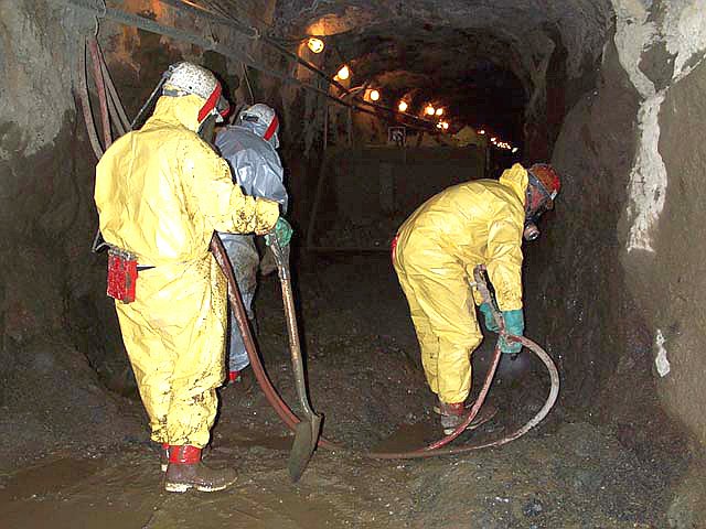 Workers remove mercury contaminated sediments from the Polar Star Mine