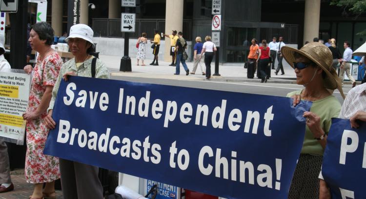 PROTESTING: Protesters were present, during the week of Aug 4-8, outside the Eutelsat location on 18th and I Street in downtown Washington, D.C. They objected to Eutelsat, a satellite company, terminating its broadcasting for New Tang Dynasty TV (NTDTV).  (Gary Feuerberg/The Epoch Times)