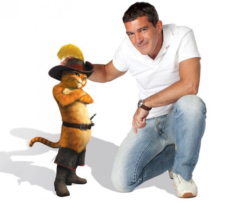 Antonio Banderas, next to the character he acts the voice of, who is a notorious fighter and outlaw that sets off on an adventure to save his town, in the comedy-animation, 'Puss In Boots.' (Courtesy DreamWorks Animation LLC)