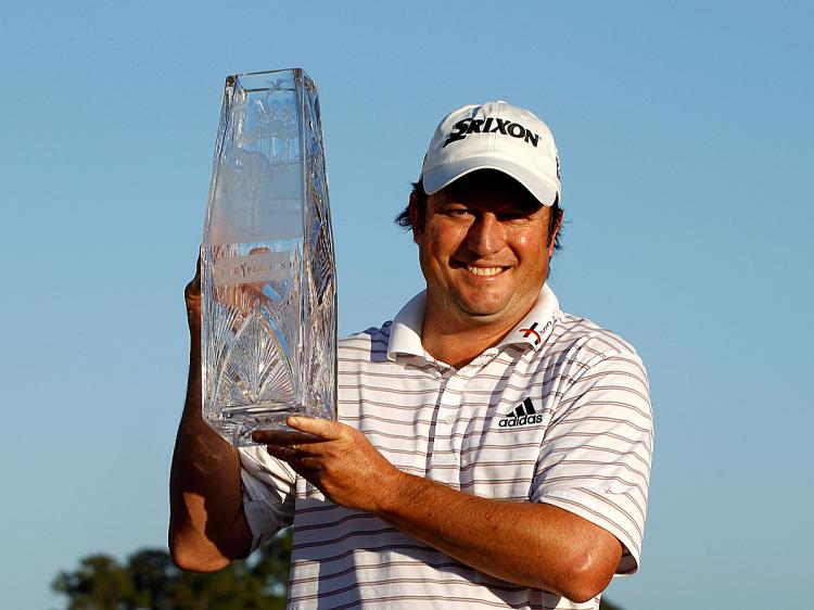 Tim Clark of South Africa smiles while holding the trophy after winning The Players Championship at TPC Sawgrass. (Scott Halleran/Getty Images)