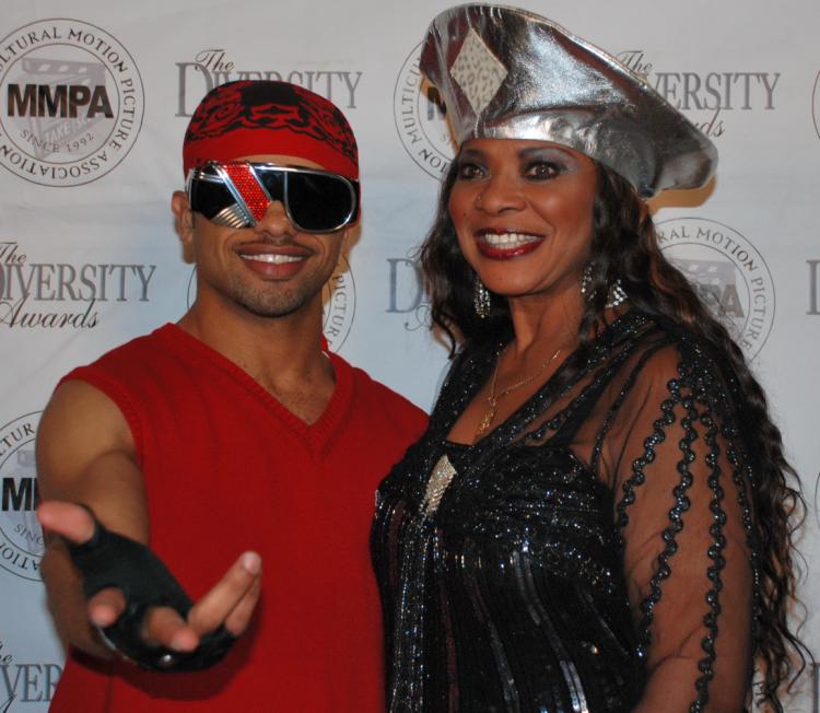 Raz-B, former member of R&B boy band B2K, alongside dancer Guadalupae D'Lushus at the MMPA 10th Annual Holiday Toy Drive Extravaganza. (Robin Kemker/Epoch Times)