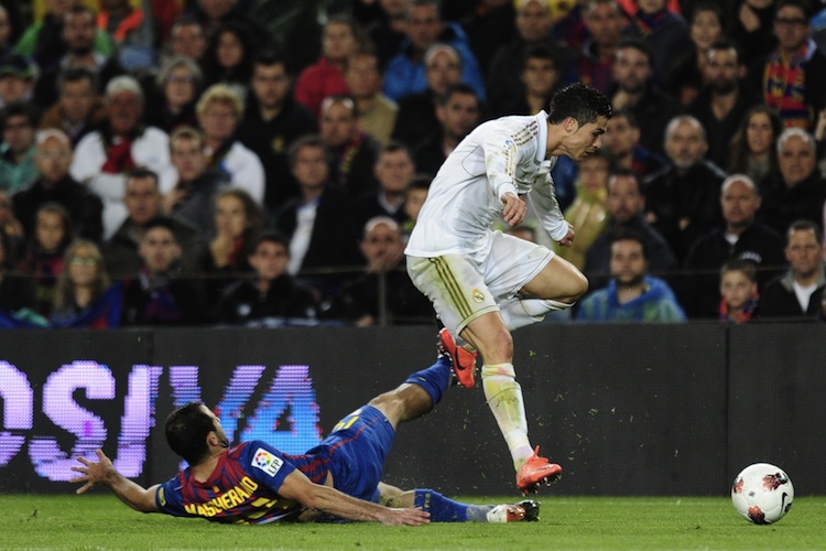 Real Madrid's Cristiano Ronaldo evades Barcelona's Javier Mascherano in the 'El Clasico' matchup at the Camp Nou in Barcelona on Saturday. (Javier Soriano/AFP/Getty Images)