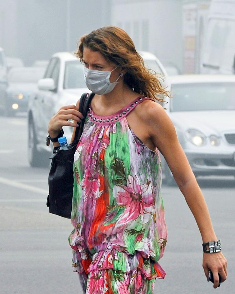 A Russian woman wears a face mask to protect herself from acrid smoke while walking in central Moscow on August 9, 2010.  (Natalia Kolesnikova/AFP/Getty Images)