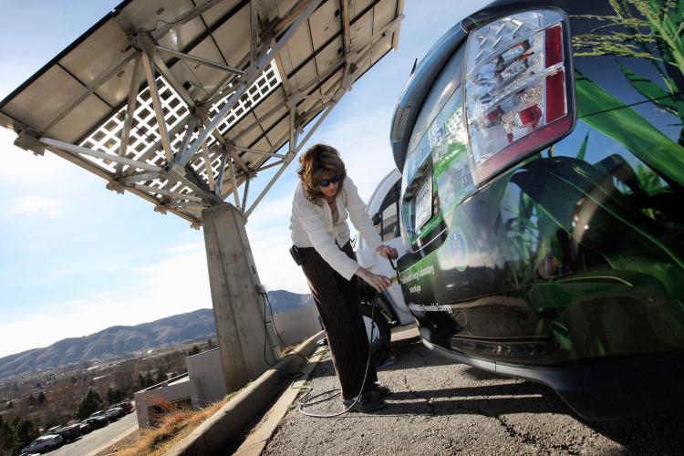 THE FUTURE OF ENERGY: Heather Lammers plugs in a Toyota Prius Hybrid to be charged by a solar energy panel at the National Renewable Energy Laboratory in Golden, Colorado, which is America's chief research and development center for renewable energy. (John Moore/Getty Images)