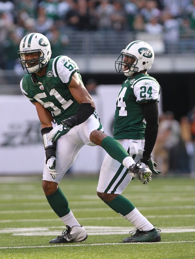 Jets' defensive players Aaron Maybin (51) and Darrelle Revis (24) celebrate Revis' fourth quarter interception against San Diego. (Nick Laham/Getty Images)