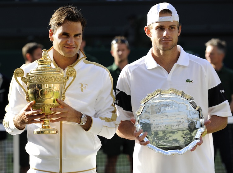 Switzerland's Roger Federer (L) holds th