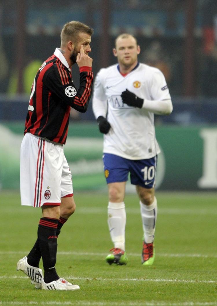 David Beckham (left) and Wayne Rooney put on a show in Milan on Tuesday. (Damian Meyer/AFP/Getty Images)