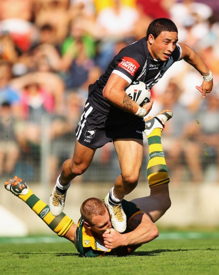 IT'S A MAN'S GAME. Kevin Locke (standing) of the New Zealand Kiwis escapes the attempted tackle of Luke Lewis (on the ground) of the Australian Kangaroos at Ausgrid Stadium on Oct. 16 in Newcastle, Australia. Lewis and the Kangaroos got the last laugh however, as they embarrassed the youthful Kiwis 42-6. Rugby is one of the most physical games, combining the heavy hitting of American football (without the pads) and the fast paced flow of soccer. (Mark Kolbe/Getty Images)