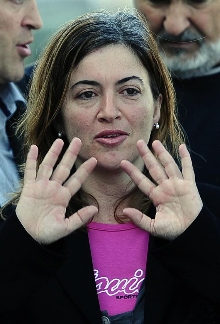 Spanish aid worker Alicia GÃ�Â¡mez waves upon her arrival at Barcelona's airport on March 10, hours after she was freed from a four-month kidnapping ordeal at the hands of al-Qaeda in Mauritania, North Africa. Gamez and two remaining hostages from the aid g (Luis Gene/AFP/Getty Images)