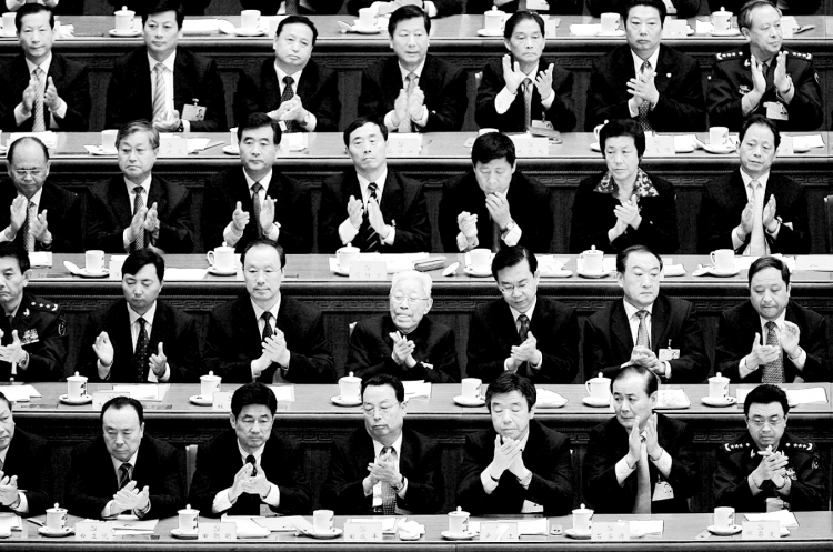 Chinese delegates applaud the result of a vote during the Chinese Communist Party Congress at the Great Hall of the People on October 21, 2007, in Beijing. (Andrew Wong/Getty Images)