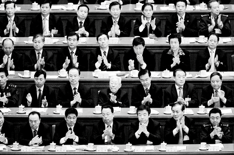 Chinese delegates applaud the result of a vote during the Chinese Communist Party Congress at the Great Hall of the People on October 21, 2007, in Beijing.     (Andrew Wong/Getty Images)