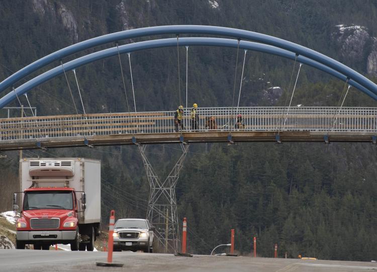 Construction workers are seen on a bridge over the Sea-to-Sky Highway Feb. 10, 2009, near Squamish, British Columbia. The highway is the road that will be used between Vancouver and Whistler during the 2010 Olympics, which is scheduled to begin Feb. 12, 2010. The highway is an award-winning infrastructure improvement public-private partnership project.  (Don Emmert/AFP/Getty Images)