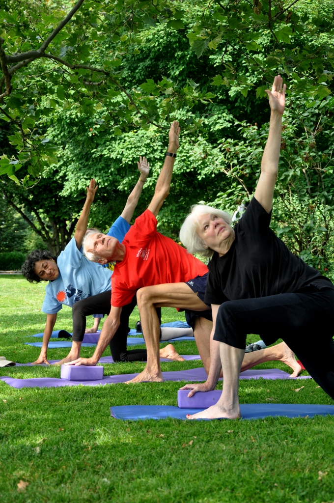 Seniors practice yoga in Carl Schurz Park in Manhattan.