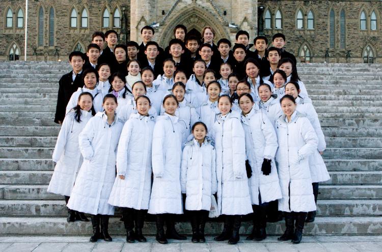 Shen Yun performers pose for a photo on the steps of Parliament Hill in Ottawa on Tuesday, the day the first slash on their bus tire appeared. (Samira Bouaou/The Epoch Times)