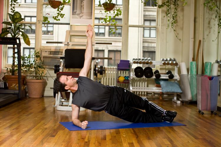 Improve your posture and tone your waist by practicing the side plank. (Henry Chan/The Epoch Times, Space Courtesy of Fitness Results)