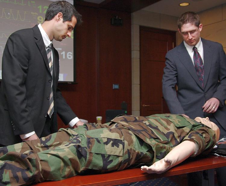 Drs. Sam DeMaria (L) and Capt. Timothy Mooney (R) demonstrate the features of a computerized mannequin for medical training. (Chris Quay/Physicians Committee for Responsible Medicine)