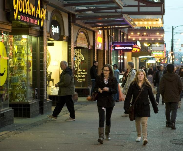 Pedestrians walk down a section of Granville Street in Vancouver lined with small local businesses and a variety of shops. Small Business Week, which celebrates Canadian entrepreneurship, runs from Oct. 17 to 23 this year. (Don Emmert/AFP/Getty Images)