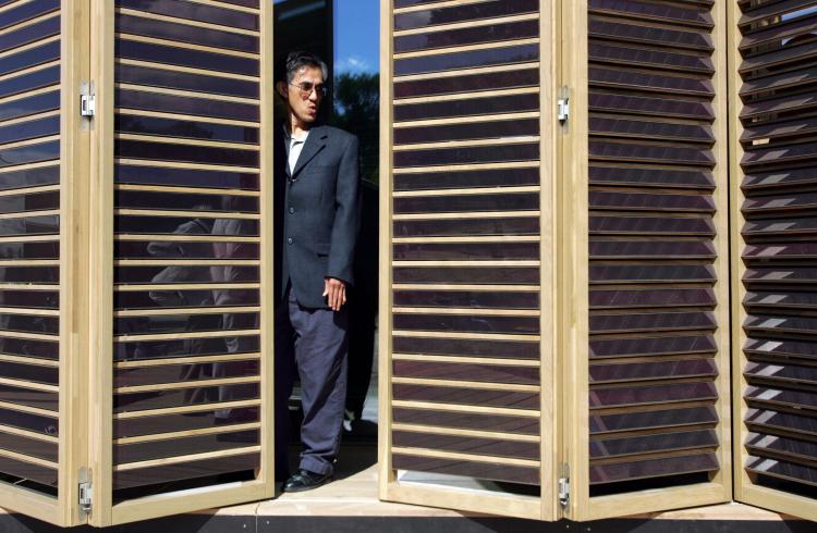 HOME OF THE FUTURE: Somchai Paarporn takes a look at movable shades of solar panels as he visits a home built by the Technische Universitat Darmstadt in Germany during the 2007 Solar Decathlon on in Washington, D.C. (SAUL LOEB/AFP/Getty Images)