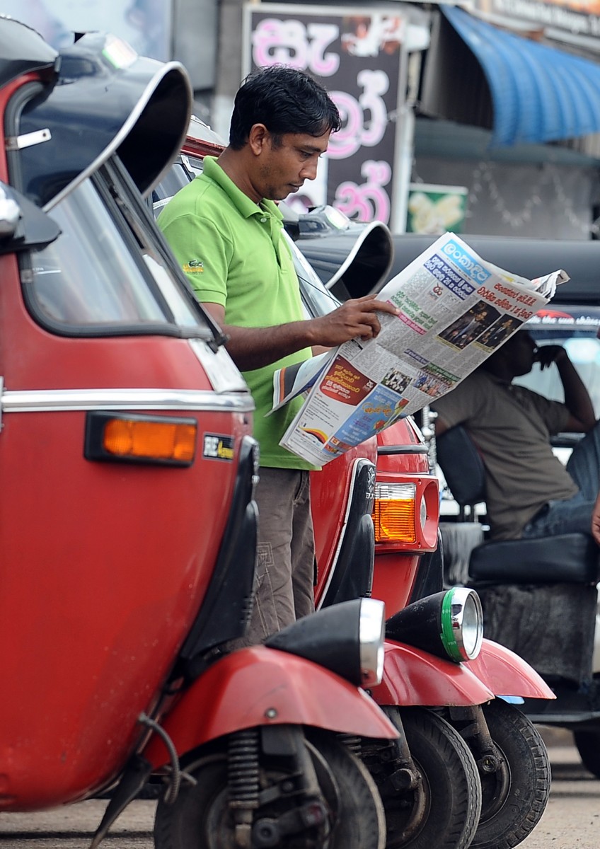 A Sri Lankan man reads a local newspaper in the capital Colombo on Sept. 17, 2012. (Lakruwan Wanniarachchi/AFP/GettyImages)