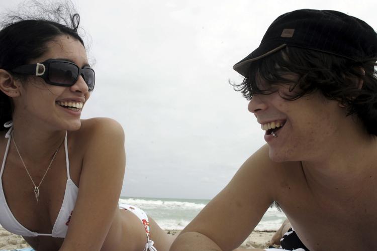 Sun exposure can lower cancer risk due to its vitamin D-enhancing effects. These Miami sunbathers are benefiting from this effect in December. (Joe Raedle/Getty Images)