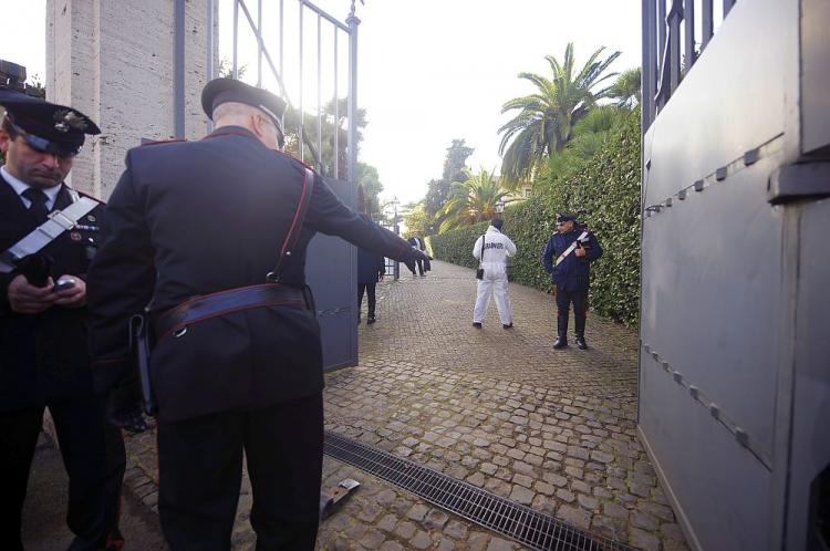 Italian Carabinieri work in front of the main gate of the Swiss embassy in Rome on Wednesday. A bomb exploded there earlier in the day, injuring one, followed by another bomb explosion at the Chilean embassy, which also injured one person, according to reports by ANSA news agency. (Filippo Monteforte/AFP/Getty Images))