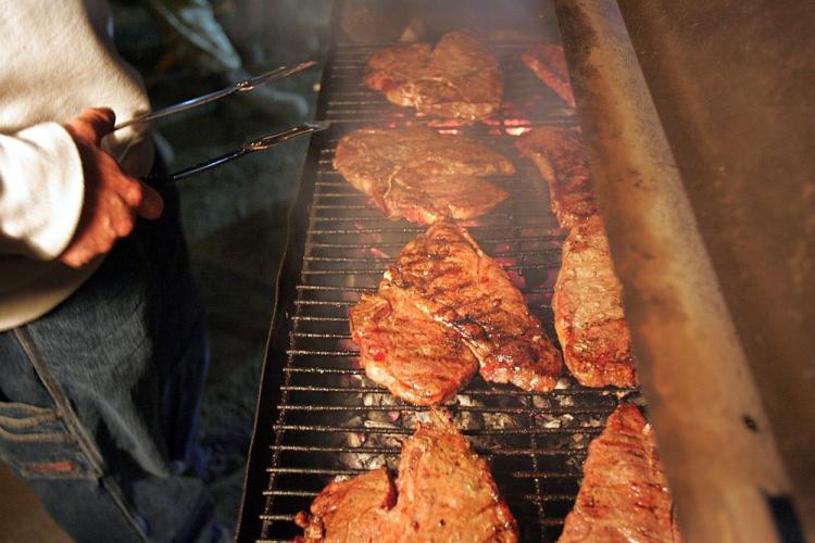 T-bone steaks cooking on a grill.  (John Moore/Getty Images )