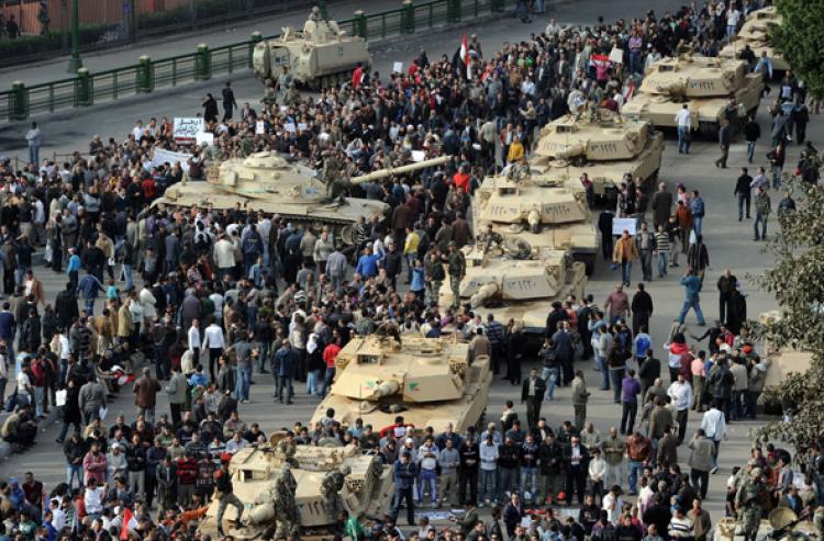 SHOW OF POWER: A column of Abrams tanks line the street as Egyptian demonstrators gather in Tahrir Square in Cairo, on Jan. 30, on the sixth day of unprecedented protests against President Hosni Mubarak's regime. (Miguel Medina/Getty Images )