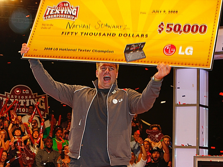 FASTEST FINGERS: Nathan Schwartz, 20, of Ohio holds his check for $50,000 after winning the LG National Texting Competition on Wednesday. (Edward Dai/The Epoch Times)