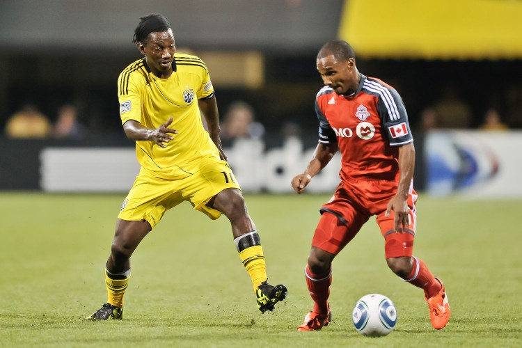 Toronto FC's Julian de Guzman takes on Columbus Crew's Andres Mendoza. Toronto FC defeated the Crew 4-2 last Saturday to win the Trillium Cup. (Jamie Sabau/Getty Images)