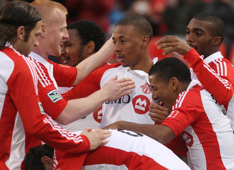 Reggie Lambe (C) celebrates his goal against the Montreal Impact in the Amway Canadian Championship Wednesday night with Ashtone Morgan (top R), Richard Eckersley (L), Torsten Frings (far L), Joao Plata (lower R), and Julian de Guzman (far C). (Tom Szczerbowski/Getty Images)