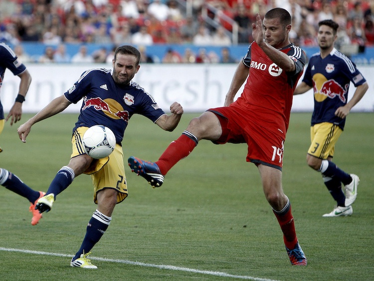 Toronto FC's Danny Koevermans battles with New York's Brandon Barklage at BMO Field in Saturday's MLS action. (Abelimages/Getty Images) 