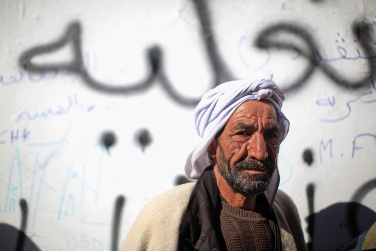 SEEKING CHANCE: A Tunisian protester joins an anti-government protest in front of the prime ministerÃ¢ï¿½ï¿½s office on Jan. 24. After weeks of protests, after ousting its president, Tunisia stands at the crossroad to democracy.  (Christopher Furlong/Getty Images)