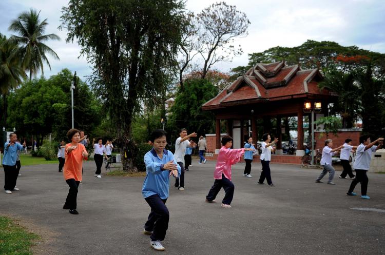 People practice Tai Chi exercises at a park in Thailand. (MANAN VATSYAYANA/AFP/Getty Images)