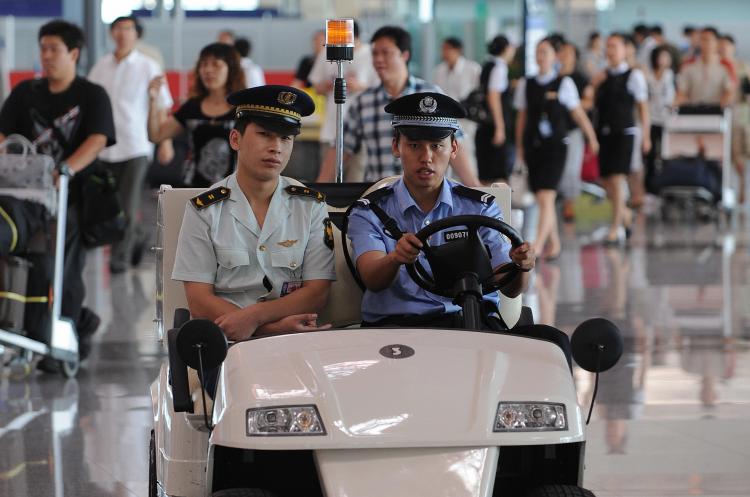 Chinese police patrol the International airport in Beijing.  (Mark Ralston/AFP/Getty Images)