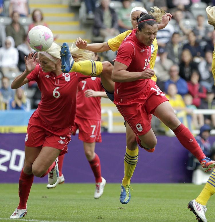 Canada's Melissa Tancredi heads home her country's second goal against Sweden on Tuesday. (Graham Stuart/AFP/Getty Images)