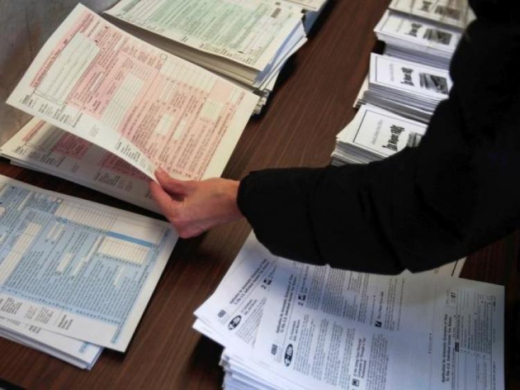 A woman picks up tax forms in the lobby of the Farley Post Office in New York City. (Chris Hondros/Getty Images)