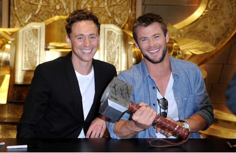 Actors Tom Hiddleston and Chris Hemsworth (R) sign autographs during Comic-Con 2010 on July 24, 2010 in San Diego, California. (Frazer Harrison/Getty Images)
