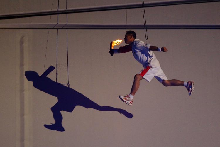 HUNG UP: Li Ning, former Olympic gymnast for China flys through the air on his way to lighting the Olympic Flame during the Opening Ceremony for the 2008 Beijing Summer Olympics at the National Stadium on August 8, 2008 in Beijing, China. (Phil Walter/Getty Images)