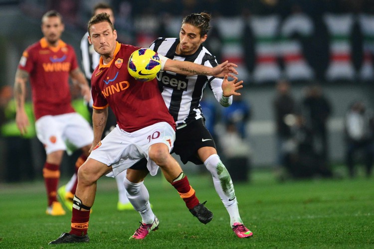 AS Roma's Francesco Totti shields the ball from Juventus defender Martin Caceres at the Olympic Stadium in Rome on Feb. 16, 2013. (Giuseppe Cacece/AFP/Getty Images)