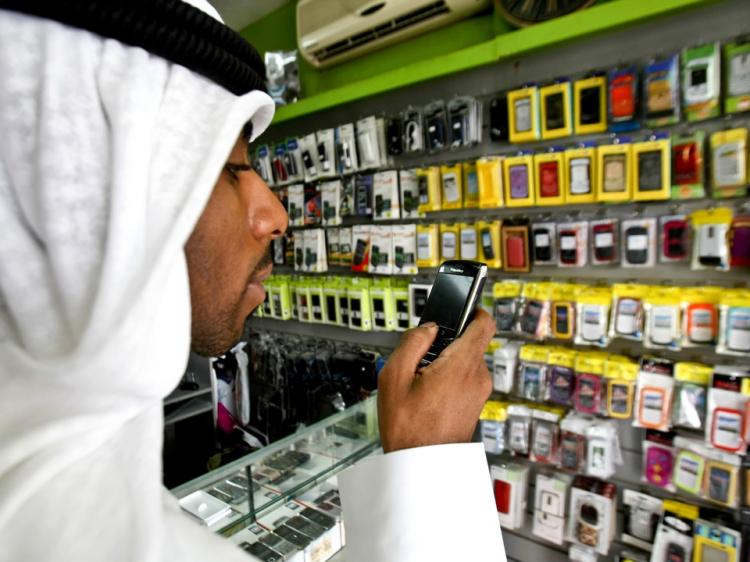 A man looks at a BlackBerry mobile phone in a store in Dubai. Following a ban on key BlackBerry services telecom companies in the United Arab Emirates are now planning to give affected customers an iPhone instead. (-/AFP/Getty Images)