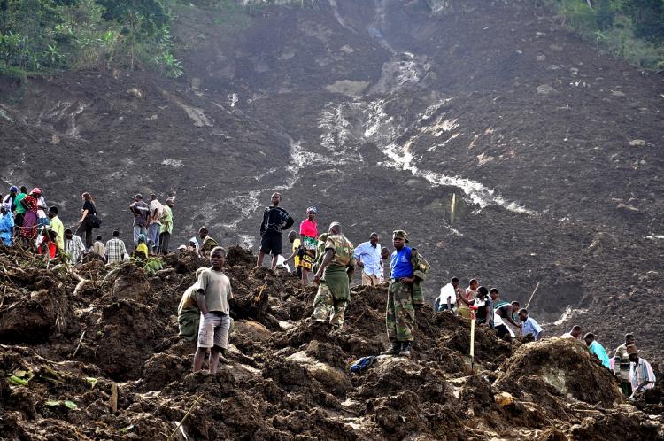 Ugandan soldiers and relatives are retrieving the bodies of villagers buried under a rain-triggered landslide in Bududa on March 3. Weather forecasters are predicting more flooding and landslides until mid-April. (Peter Busomoke/AFP/Getty Images)