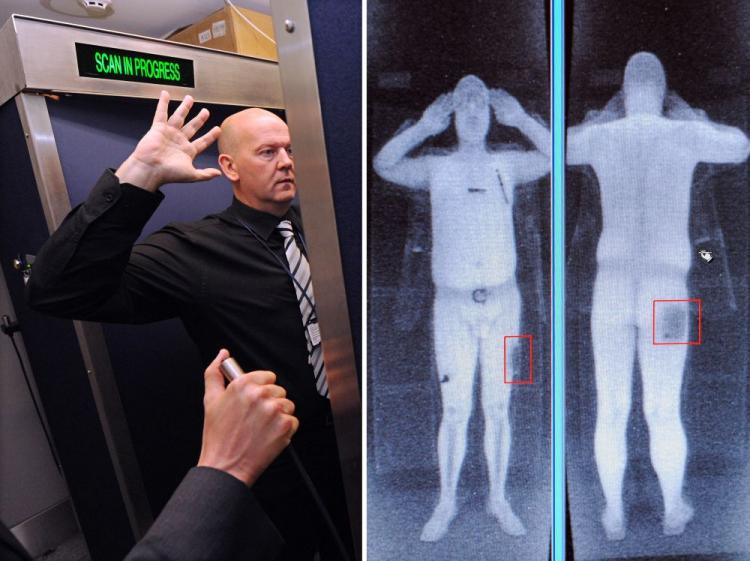 An airport staff member demonstrates a full-body scan at Manchester Airport in Britain. Two women leaving from that airport to Pakistan were not allowed to board the plane after refusing to submit to be scanned. (Paul Ellis/AFP/Getty Images)