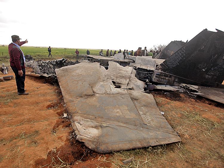 Libyans gather around the wreckage of a US F-15 fighter jet in Ghot Sultan, South-East of Benghazi on March 22 after crashing while on a mission against Moammar Gadhafi's air defenses. The U.S. Africa Command said the aircraft had experienced equipment malfunction, but the two pilots had ejected and were safe. (Patrick Baz/AFP/Getty Images)