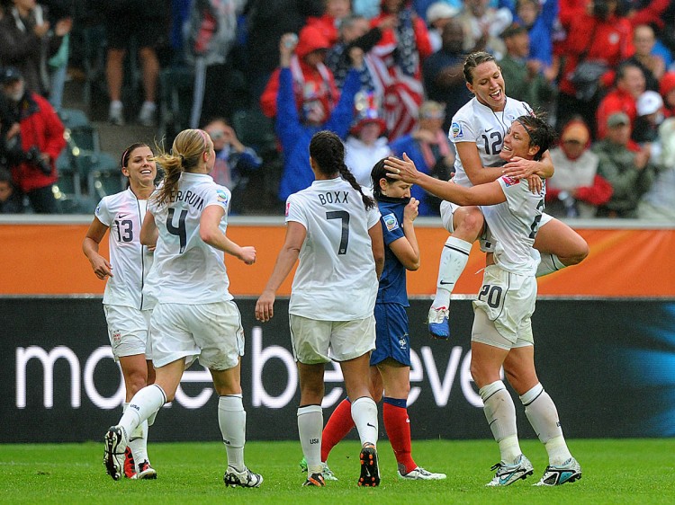 VICTORY: Lauren Cheney (2ndR), Abby Wambach (R) and teammates celebrate after their victory after the FIFA women's football World Cup semi-final match vs. France. (Christof Stache/AFP/Getty Images)