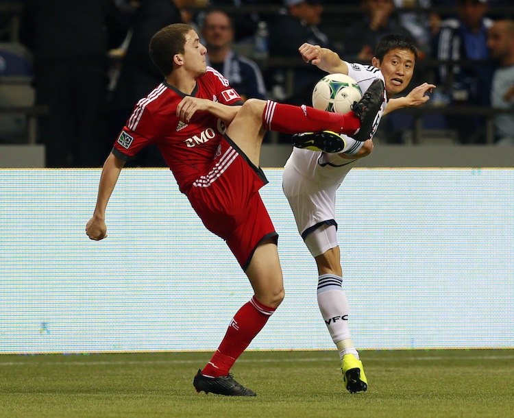 Hogan Ephraim of Toronto FC (L) and Young-Pyo Lee of Vancouver Whitecaps FC compete for the ball during their MLS game at BC Place March 2, 2013 in Vancouver, British Columbia, Canada. (Jeff Vinnick/Getty Images)