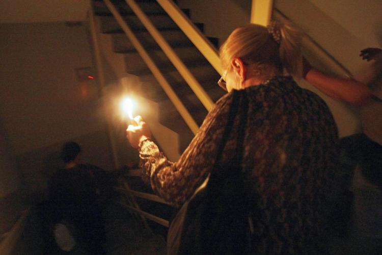 A woman walks downstairs with a lighter inside a public building in downtown Caracas on April 29, 2008 during a power cut. The blackout came at 20h45 GMT leaving half Venezuela without energy.  (Juan Barreto/AFP/Getty Images)